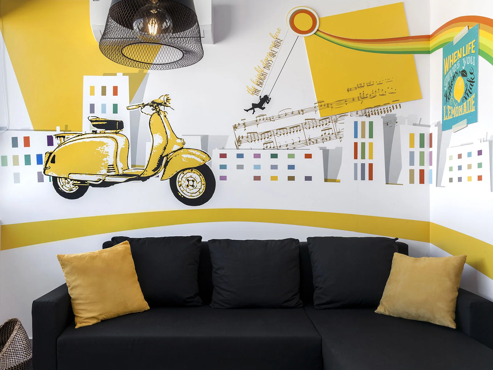 Yellow wall graphics with a Vespa and cityscape in a The Athenians apartment