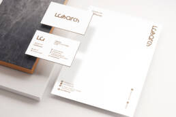 Labarch corporate stationery with white letterhead and gold logo on business cards