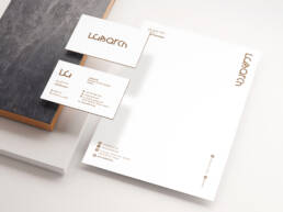 Labarch corporate stationery with white letterhead and gold logo on business cards