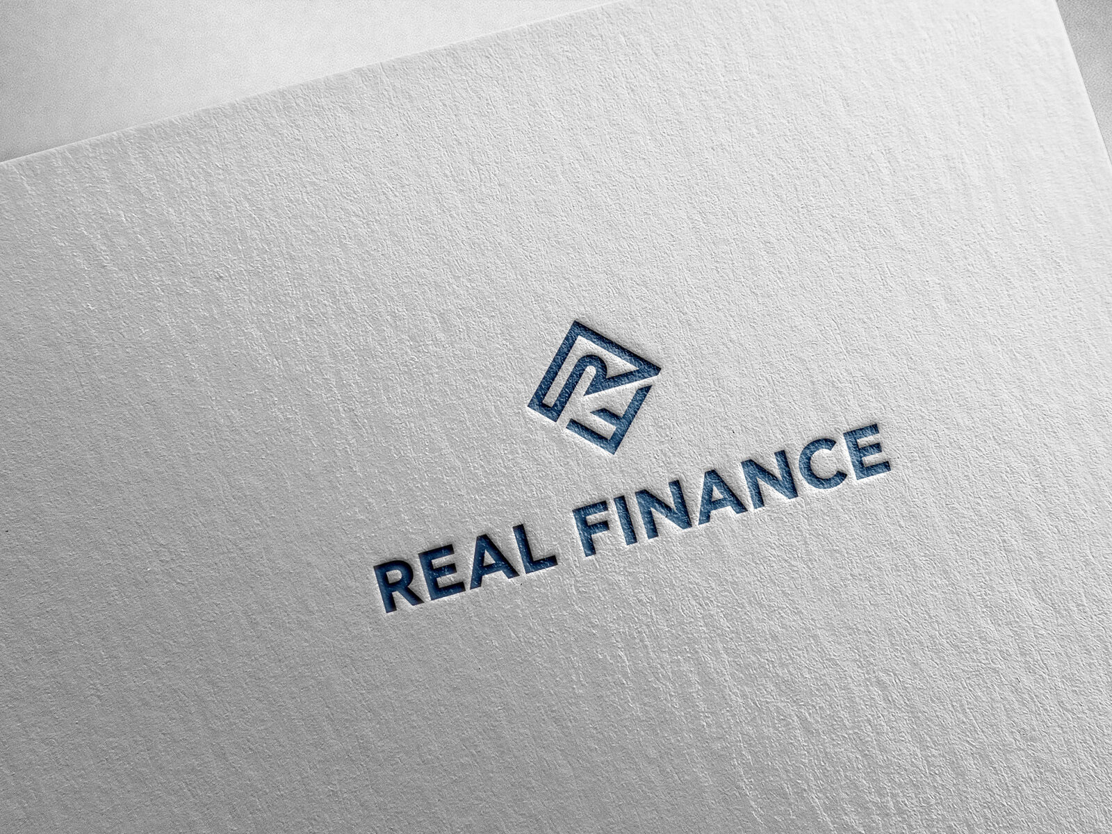 Real Finance logo embossed on white paper