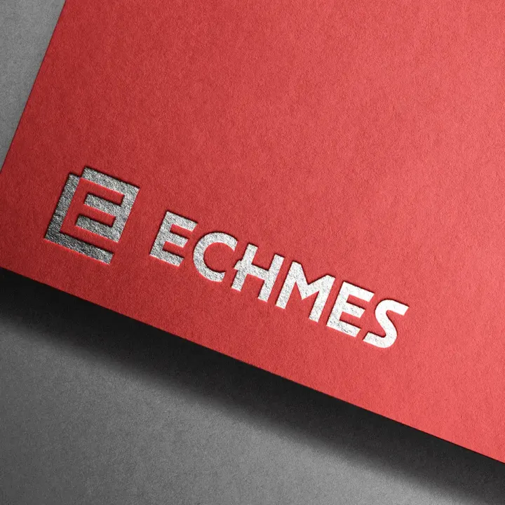 ECHMES logo in embossed silver foil on textured red paper