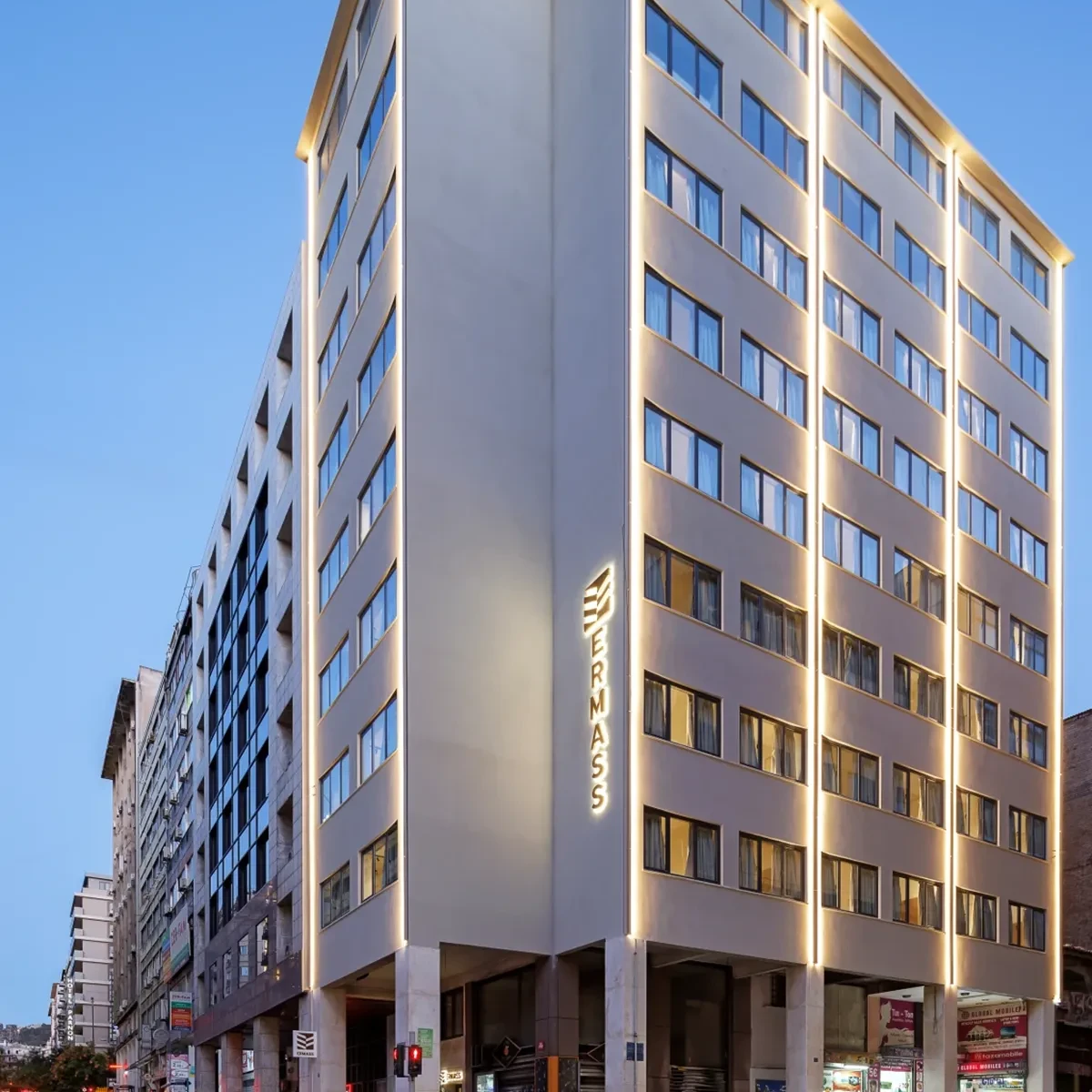 ERMASS building exterior with illuminated signage in Athens