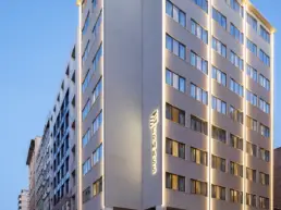 ERMASS building exterior with illuminated signage in Athens