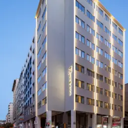 ERMASS building exterior with illuminated signage in Athens