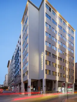 ERMASS building exterior with illuminated signage in Athens