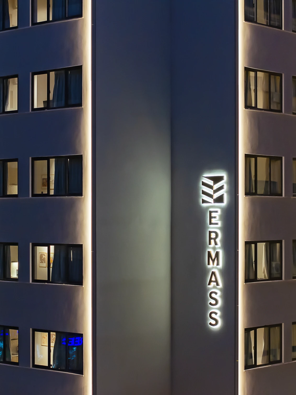 Illuminated ERMASS sign within the recessed building façade