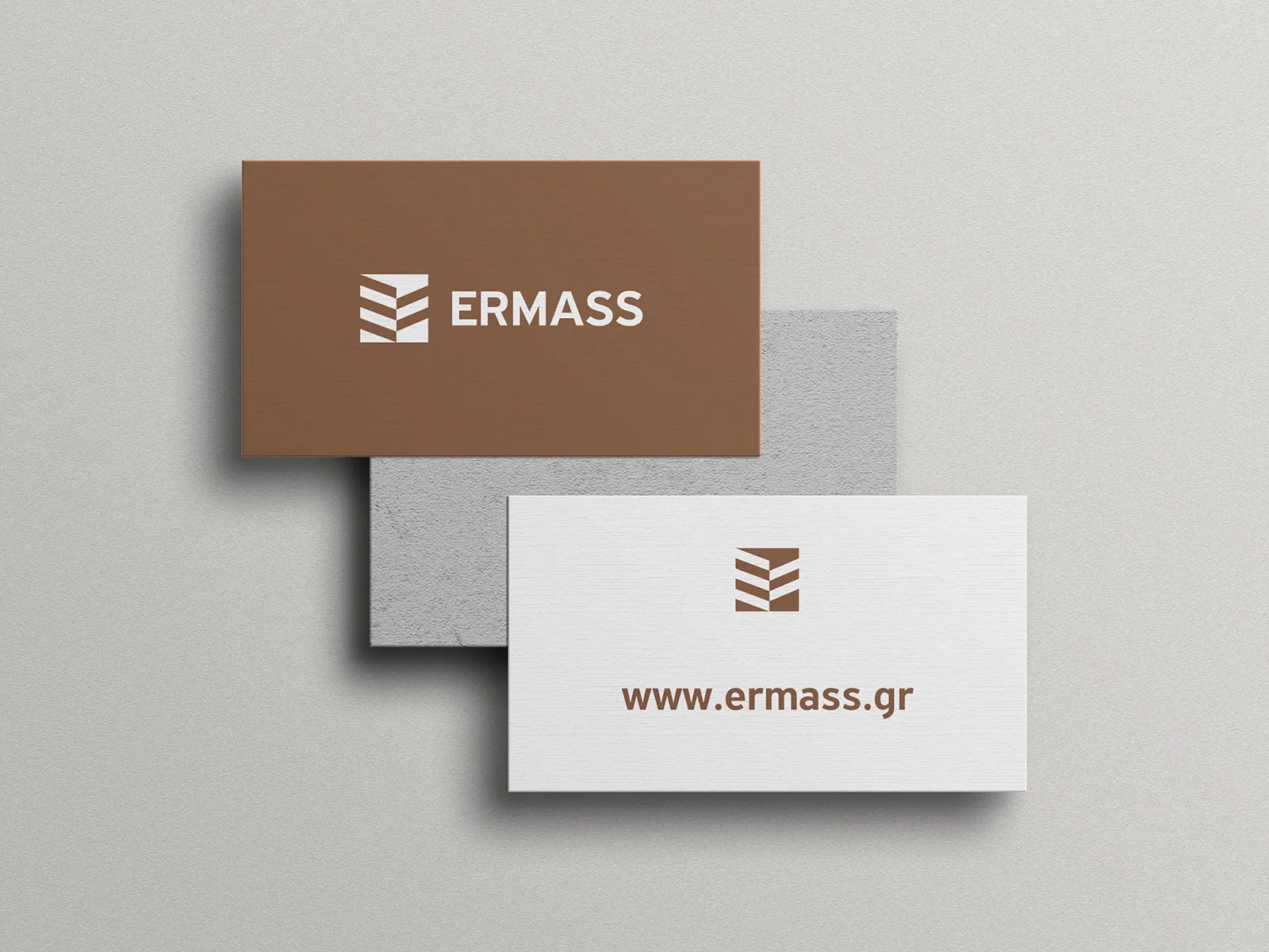 ERMASS business cards in warm brown and off-white