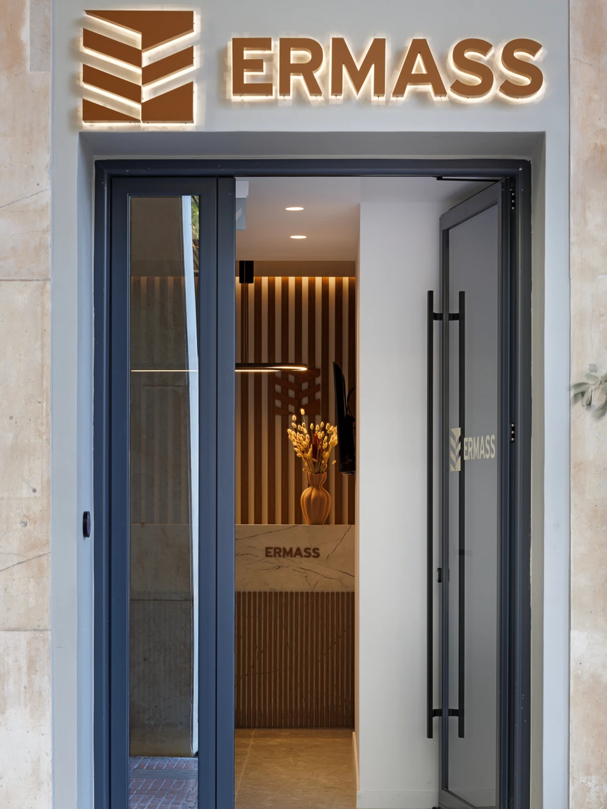 ERMASS logo and dimensional lettering above the entrance