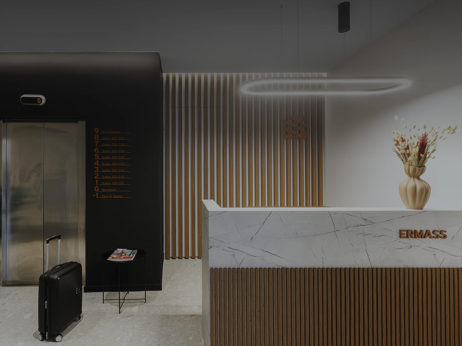 ERMASS logo and signage at the marble reception desk