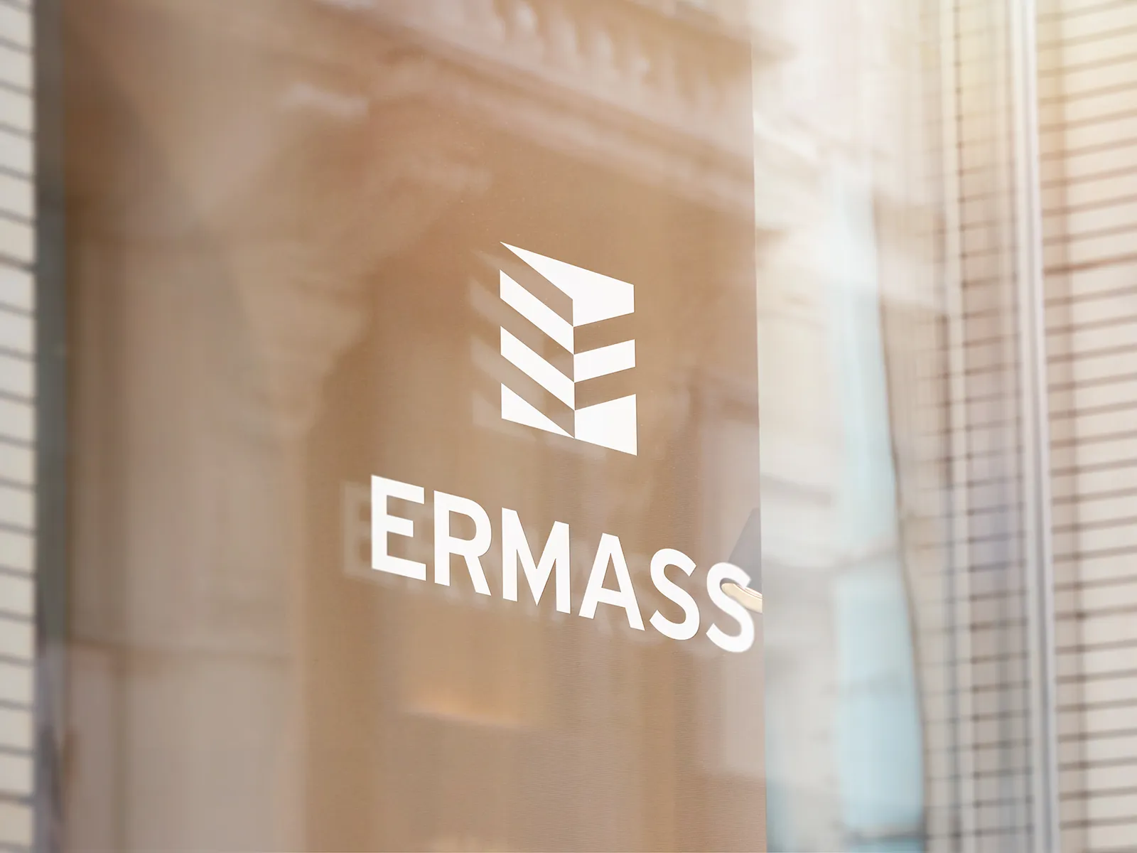 ERMASS geometric monogram and wordmark on glass