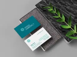 Praxis Pharmacy business cards with the teal and white visual identity