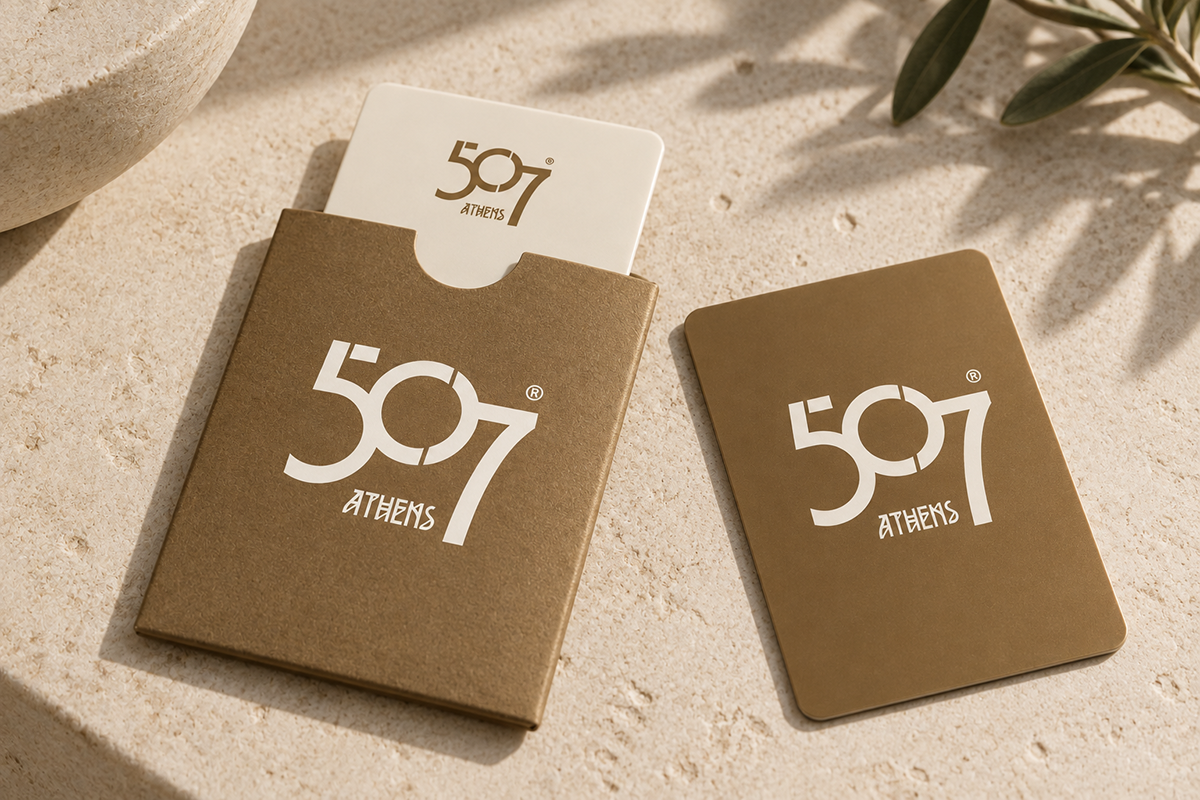 507 Athens branded hotel key cards with bronze paper sleeve on limestone