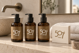 507 Athens identity on amber amenities bottles and an ivory soap carton
