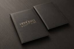 Charcoal leather bill folder mockups with the Opposite logo in muted gold