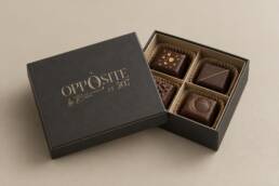 Charcoal petit-fours box mockup with gold Opposite branding and four chocolates