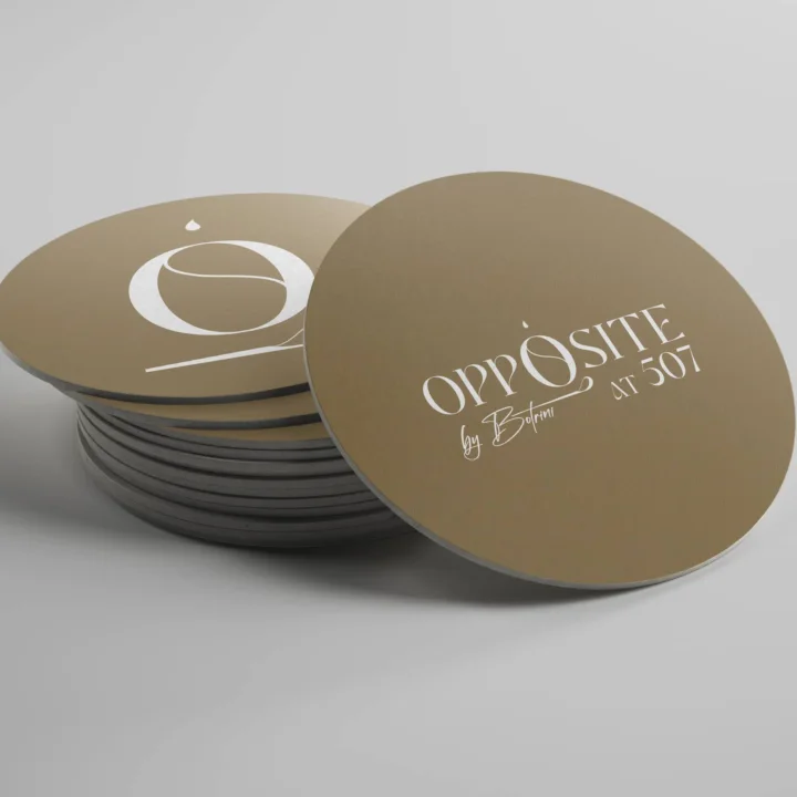 Gold round coaster mockups with the Opposite wordmark and O monogram