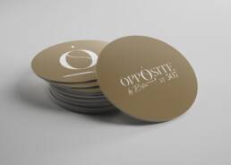 Gold round coaster mockups with the Opposite wordmark and O monogram