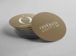 Gold round coaster mockups with the Opposite wordmark and O monogram