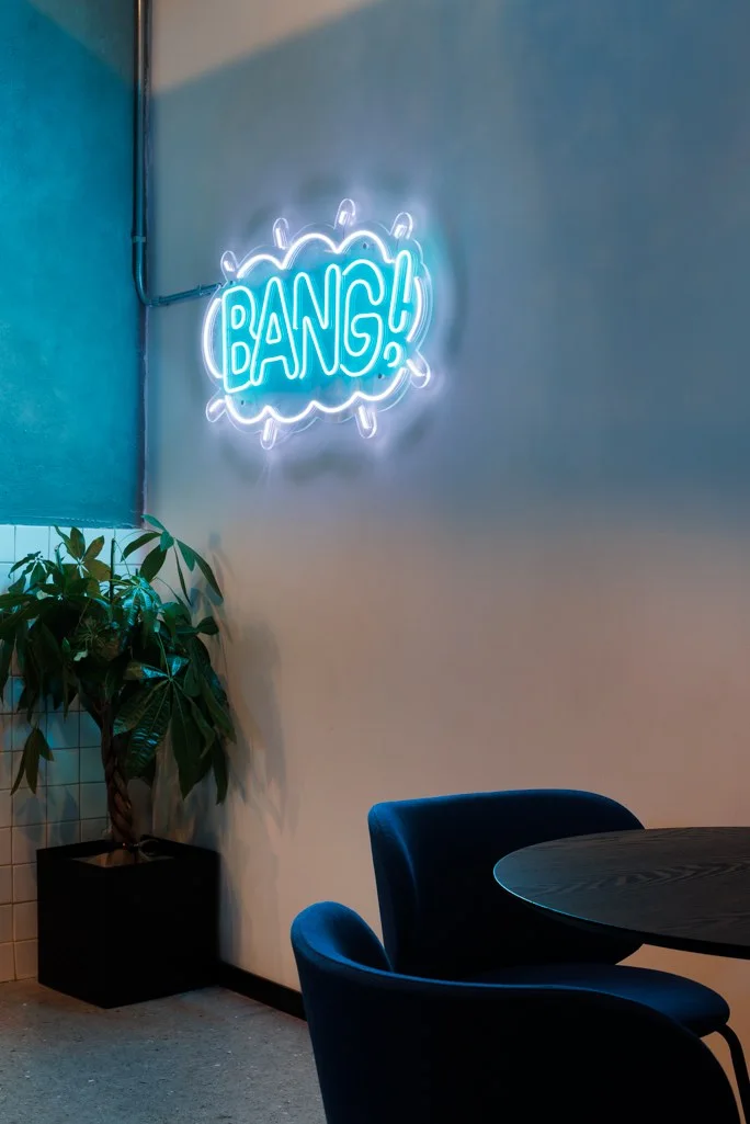 Bang neon graphic in the Retroverse lounge