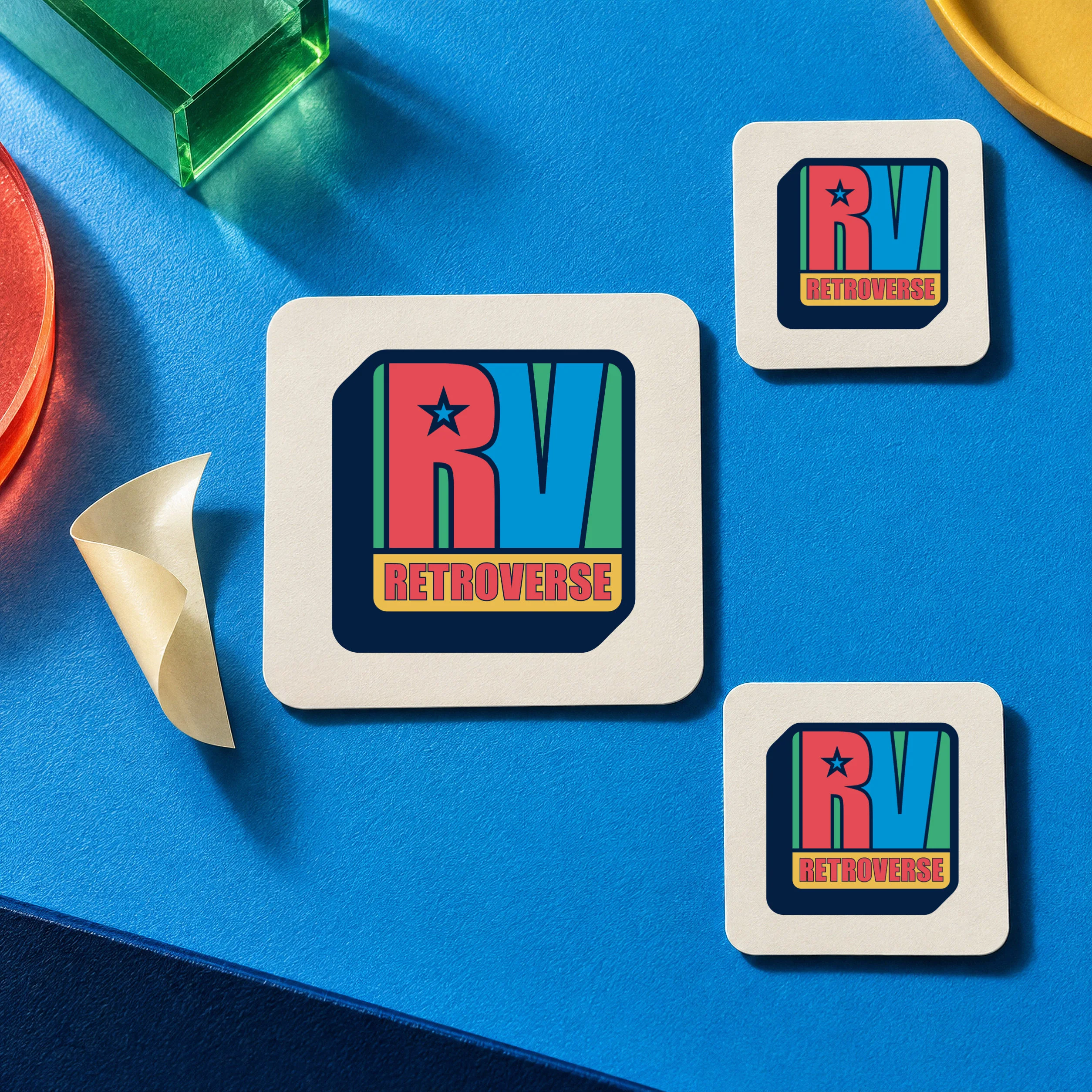 Three stickers with the original Retroverse RV logo on a bright blue surface