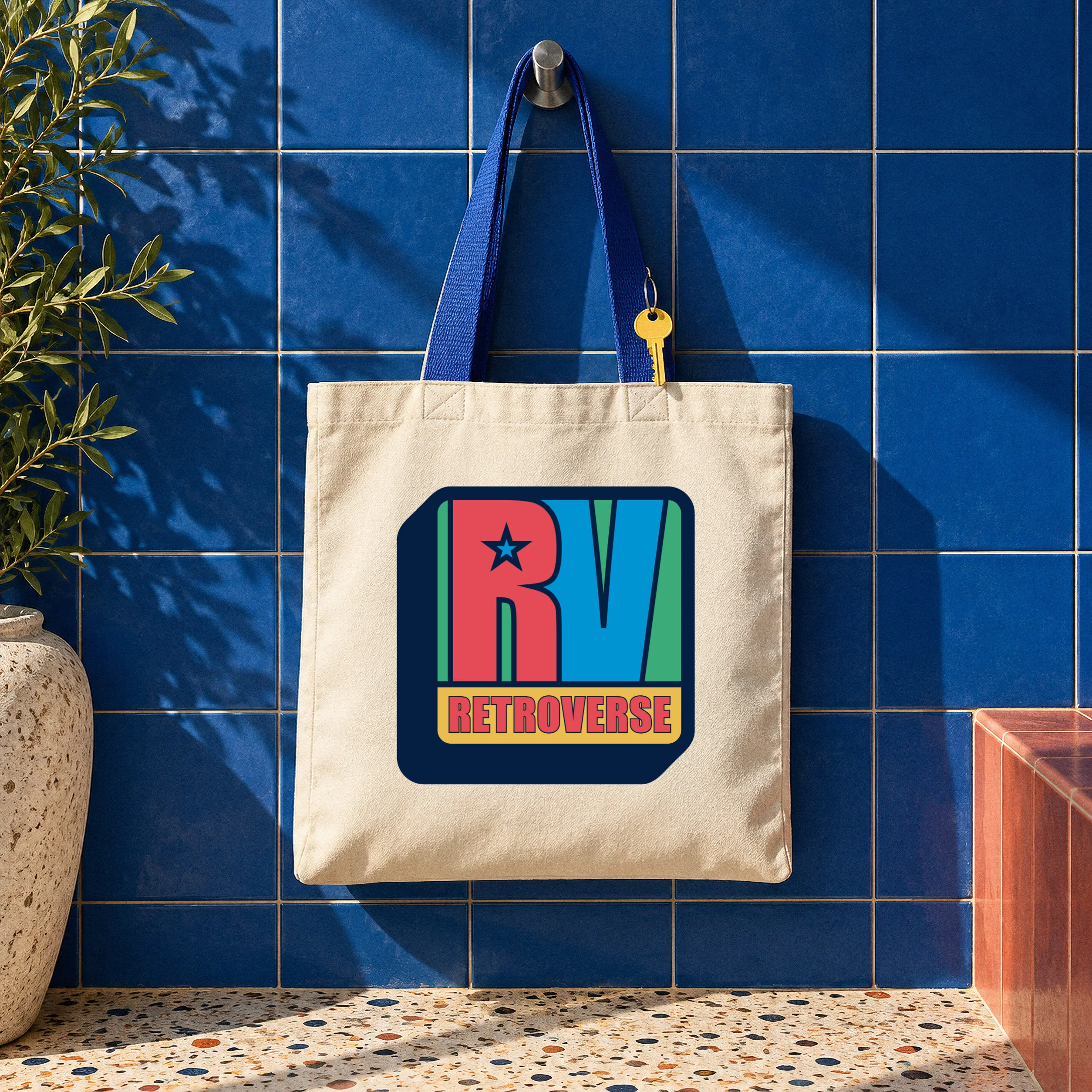 Canvas tote bag with the original Retroverse RV logo, photographed against a blue tiled wall